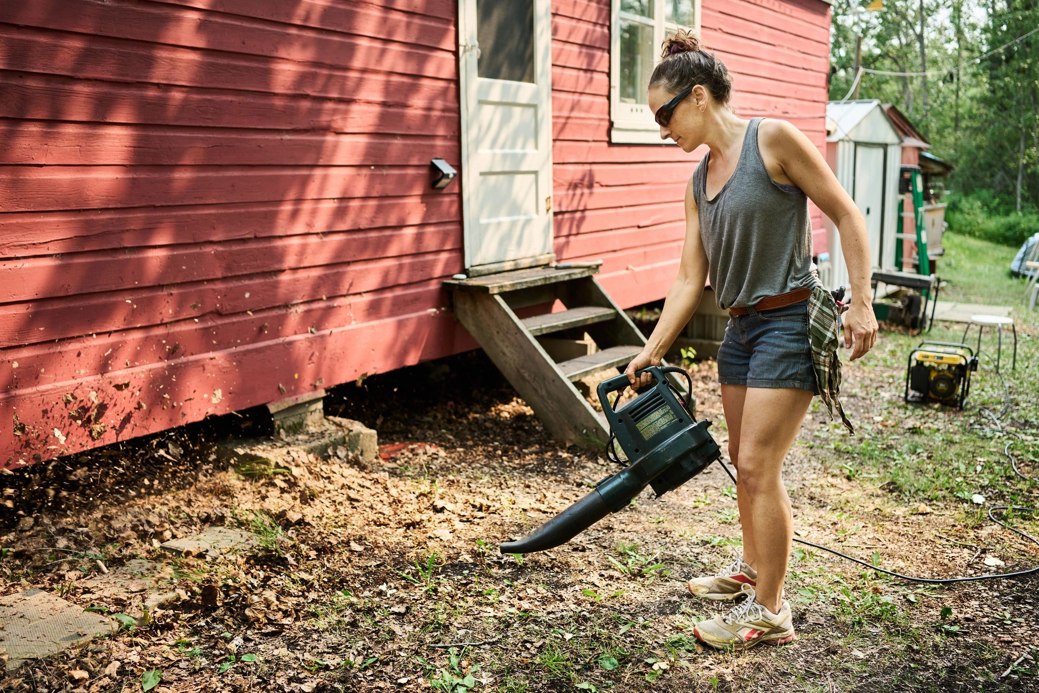 Person using a leaf blower in a yard