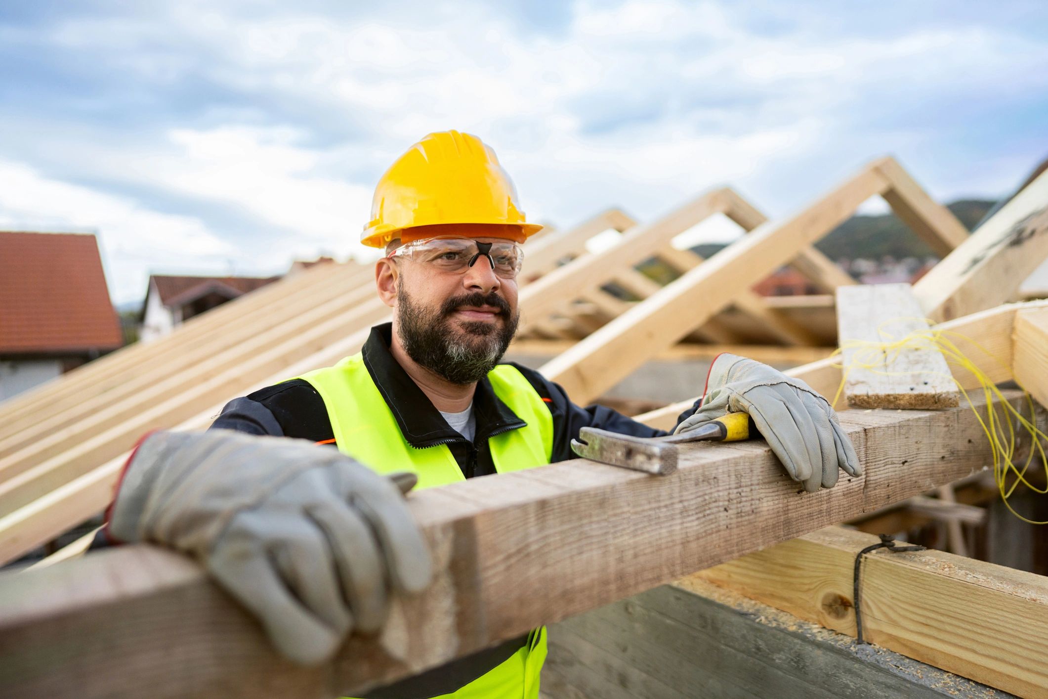 Contractor measuring and working on framing at a jobsite