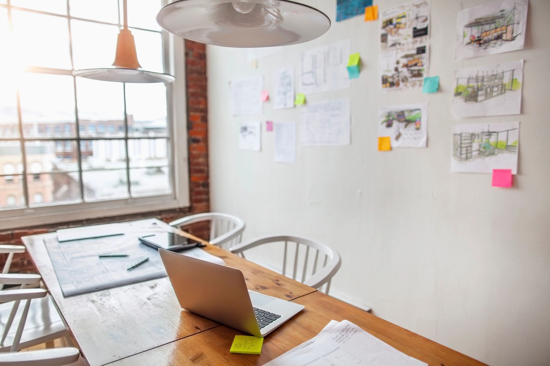 Workspace with laptop and notes for equipment research