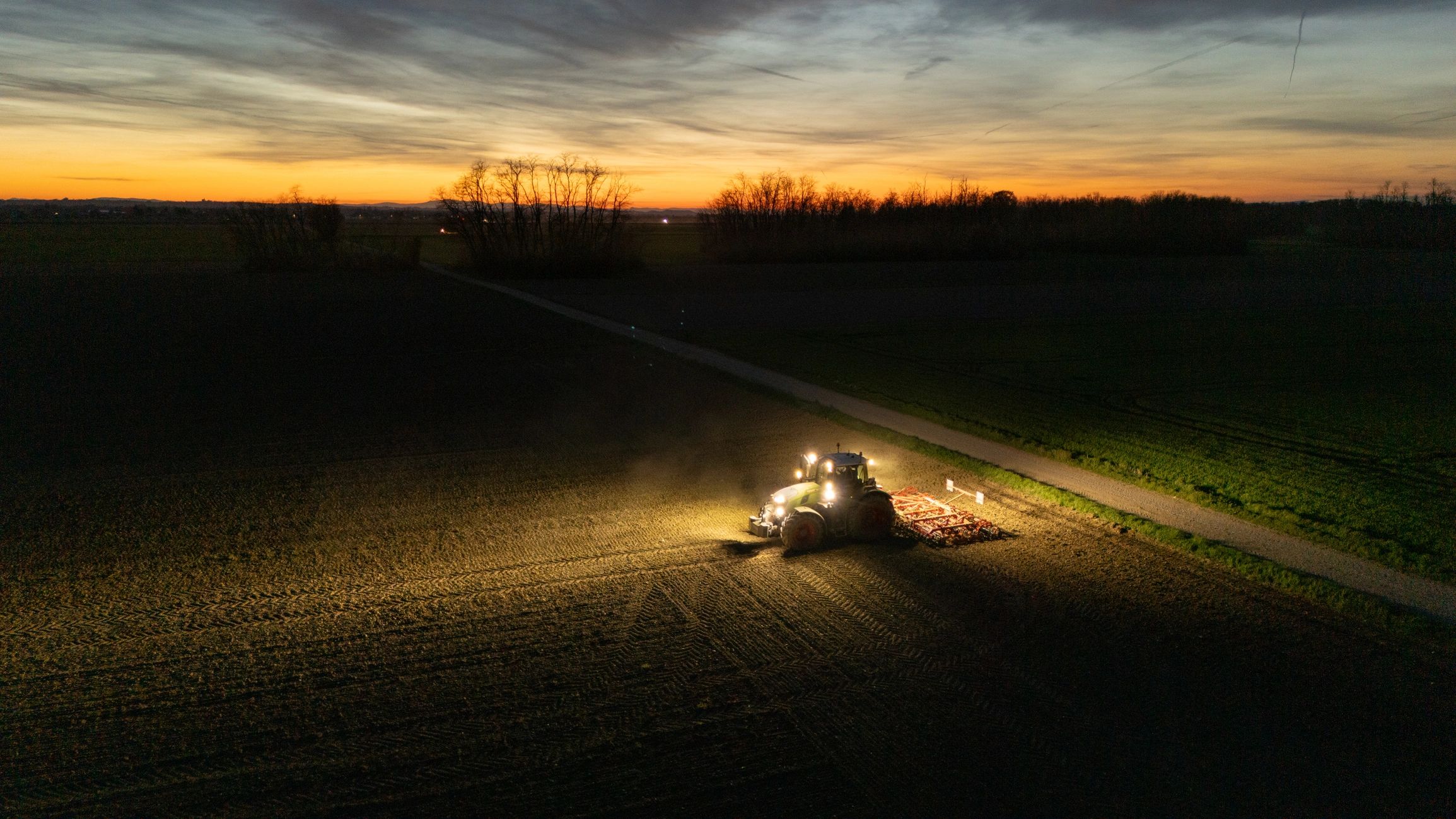 Tractor working a field at dusk