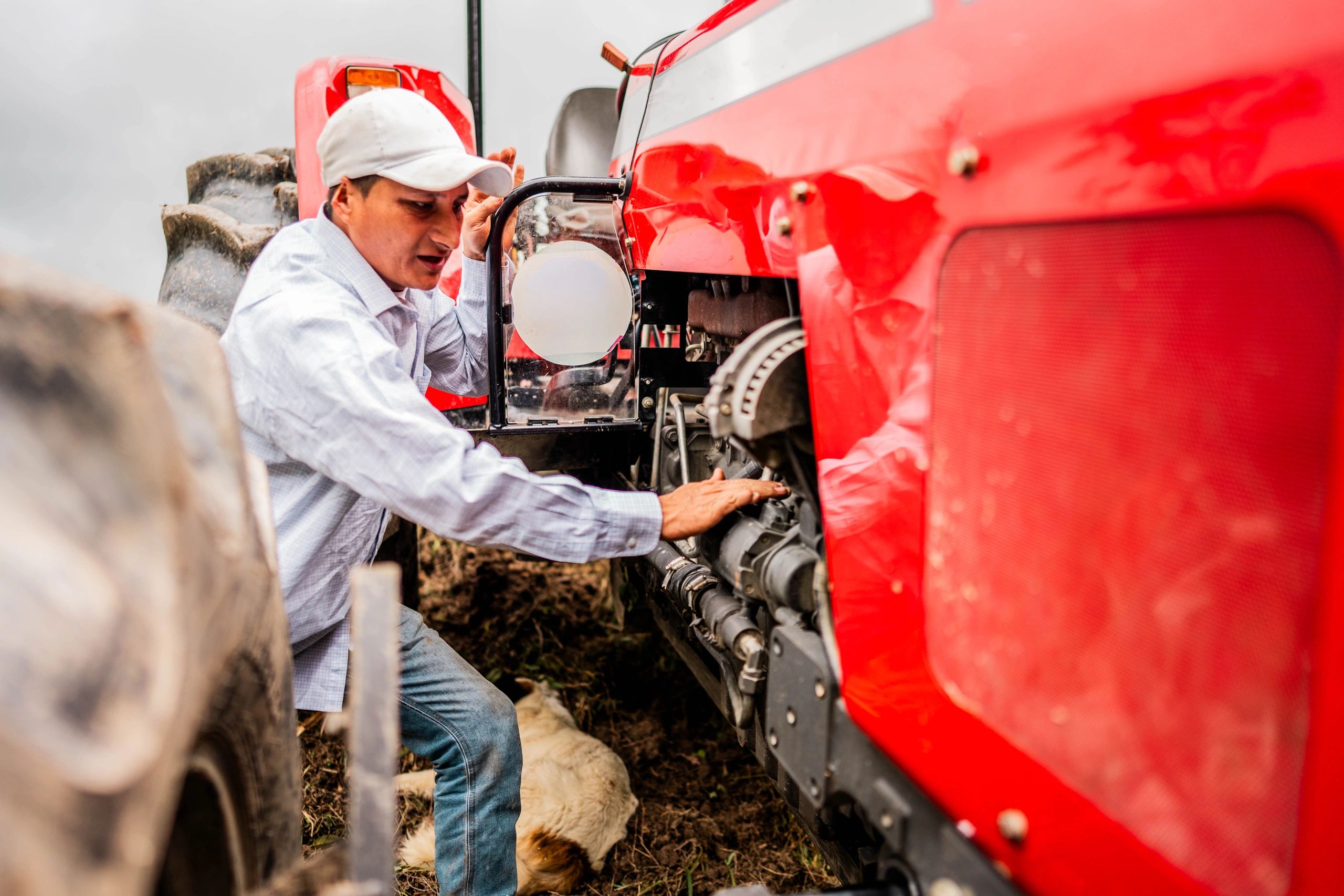 Man servicing a tractor engine
