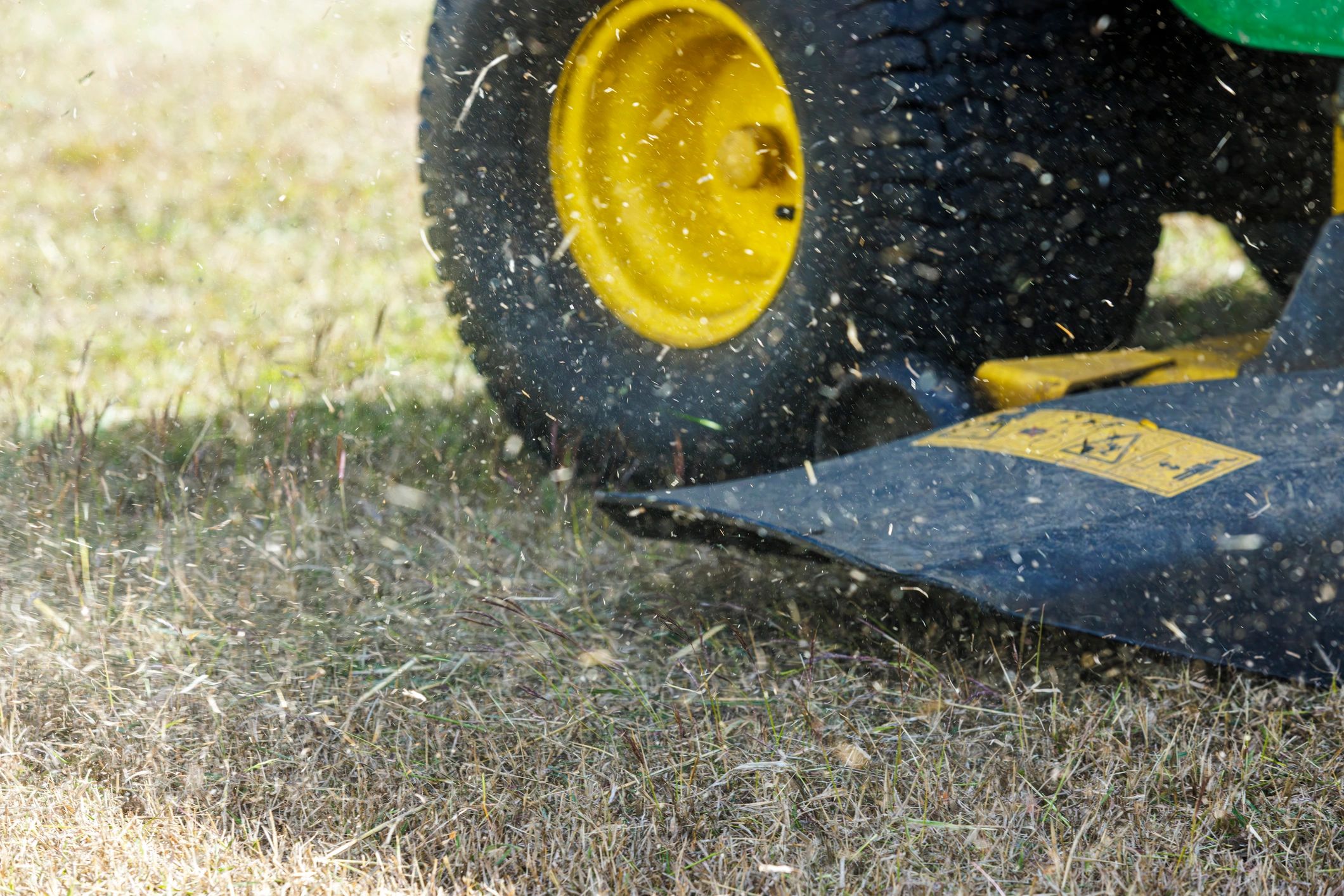 Close-up of mower cutting grass