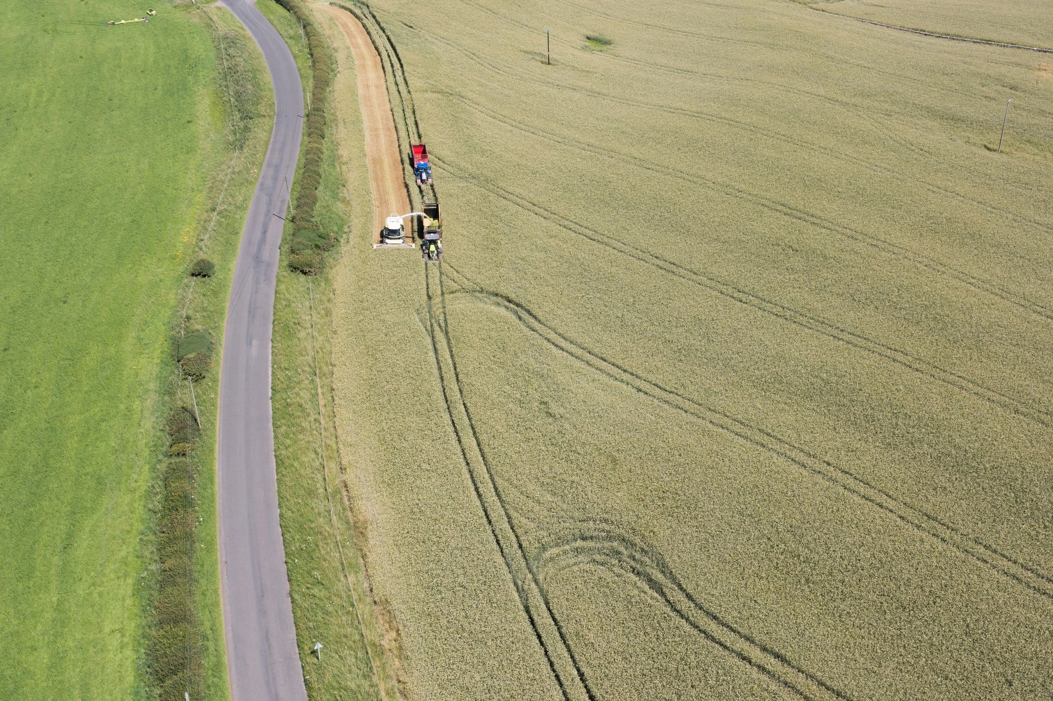Aerial view of harvesting equipment working in a field