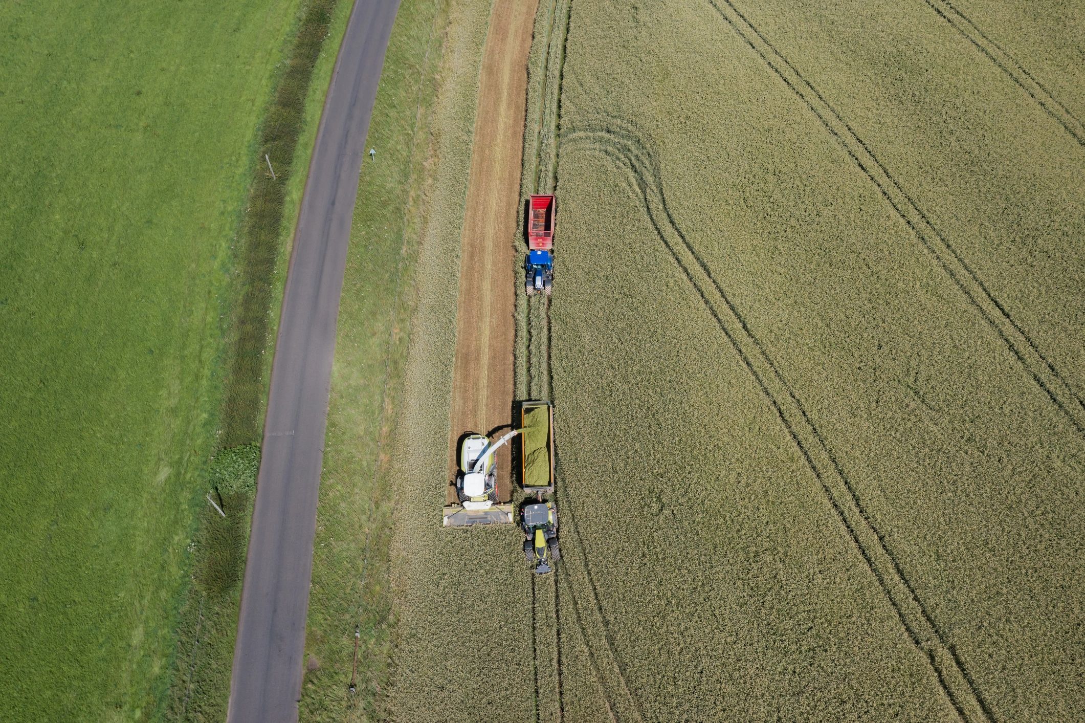 Aerial view of harvesting equipment working in a field