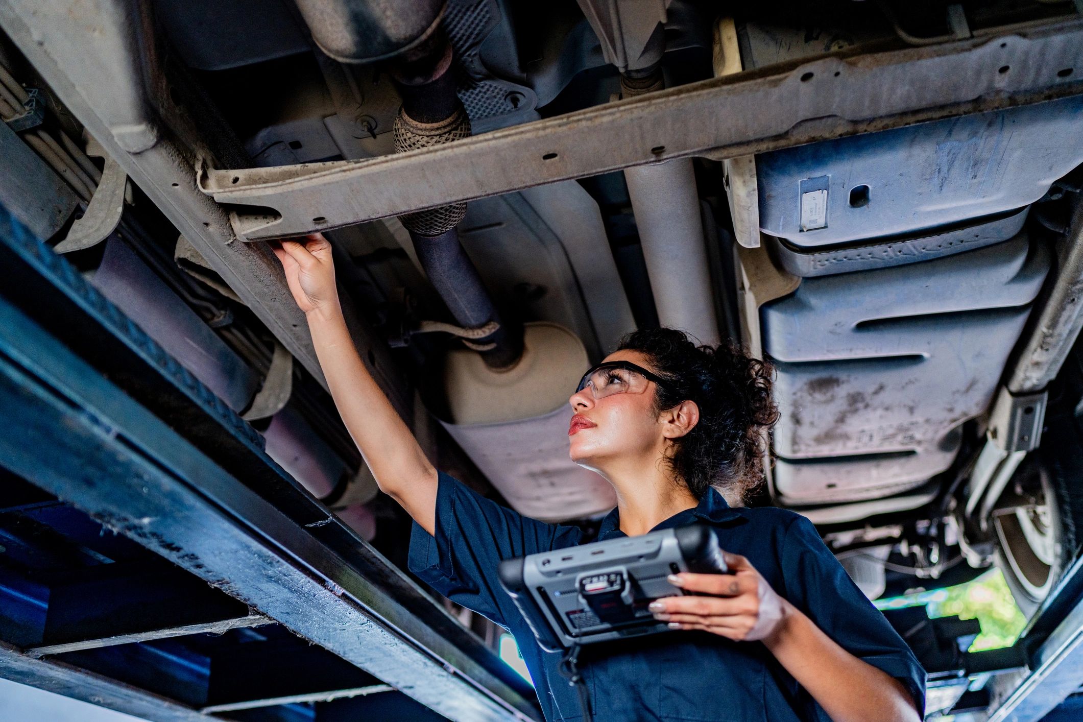 Mechanic inspecting equipment in a workshop