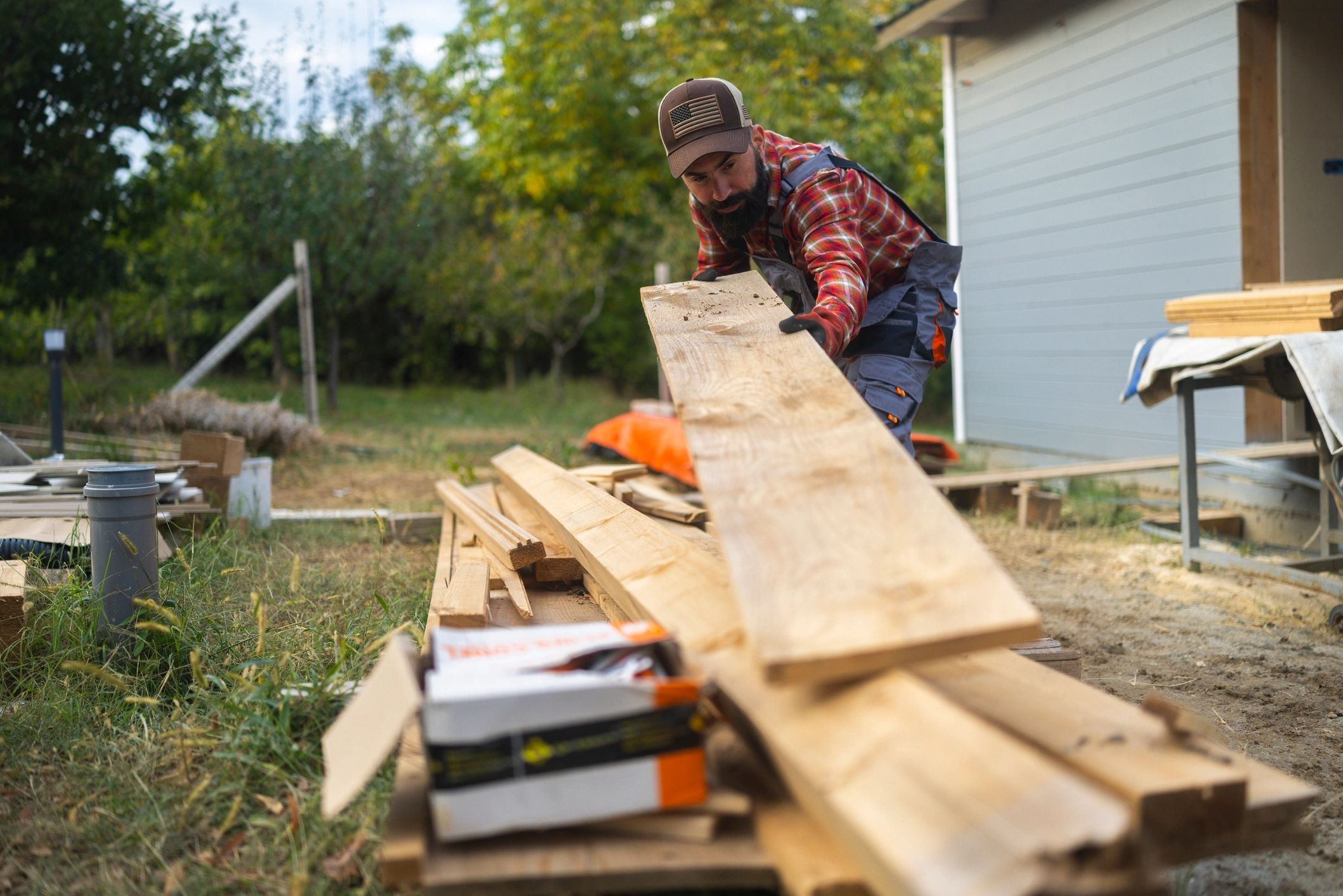 Carpenter working with lumber outdoors