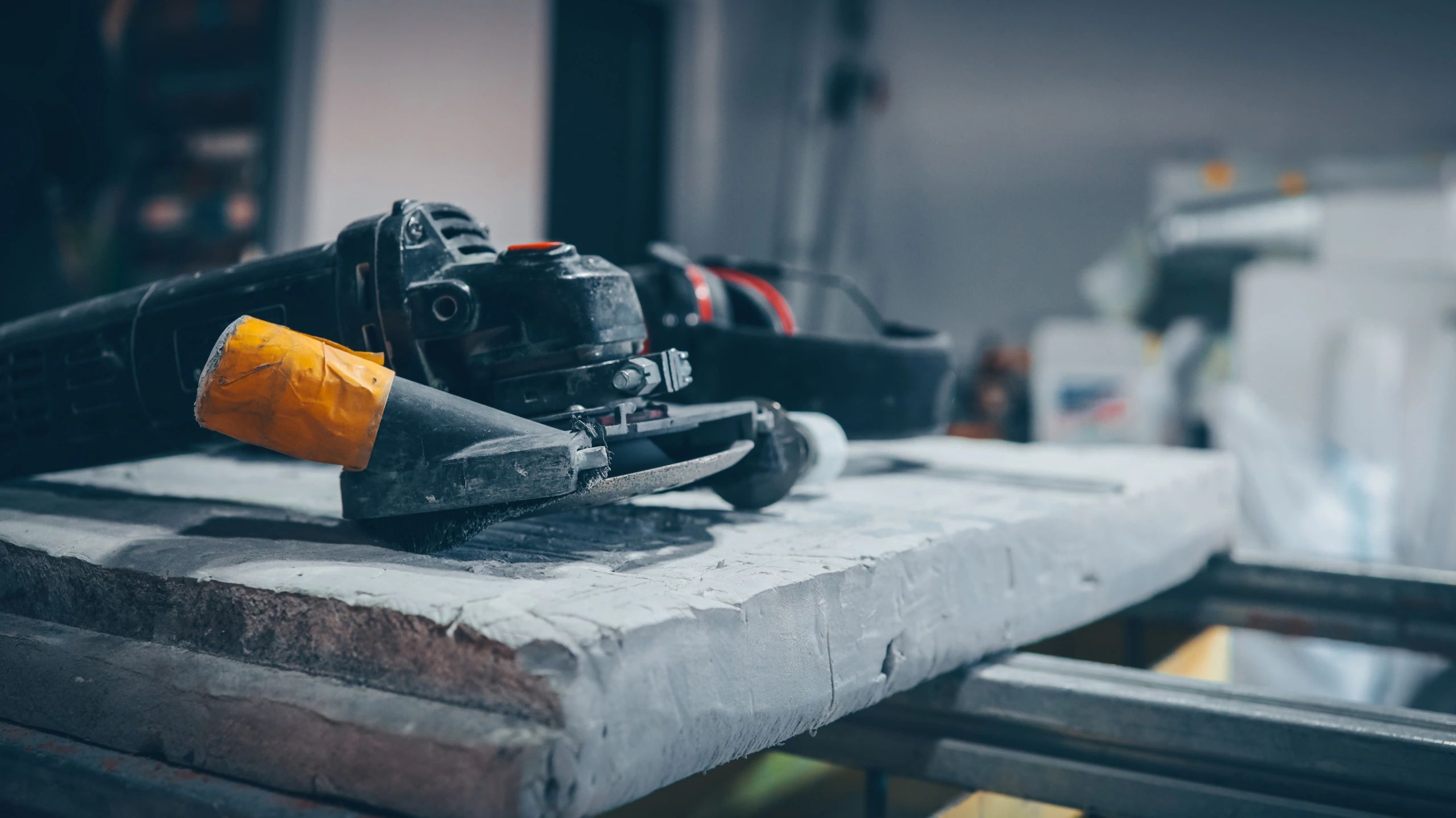 Angle grinder and safety glasses on a workbench
