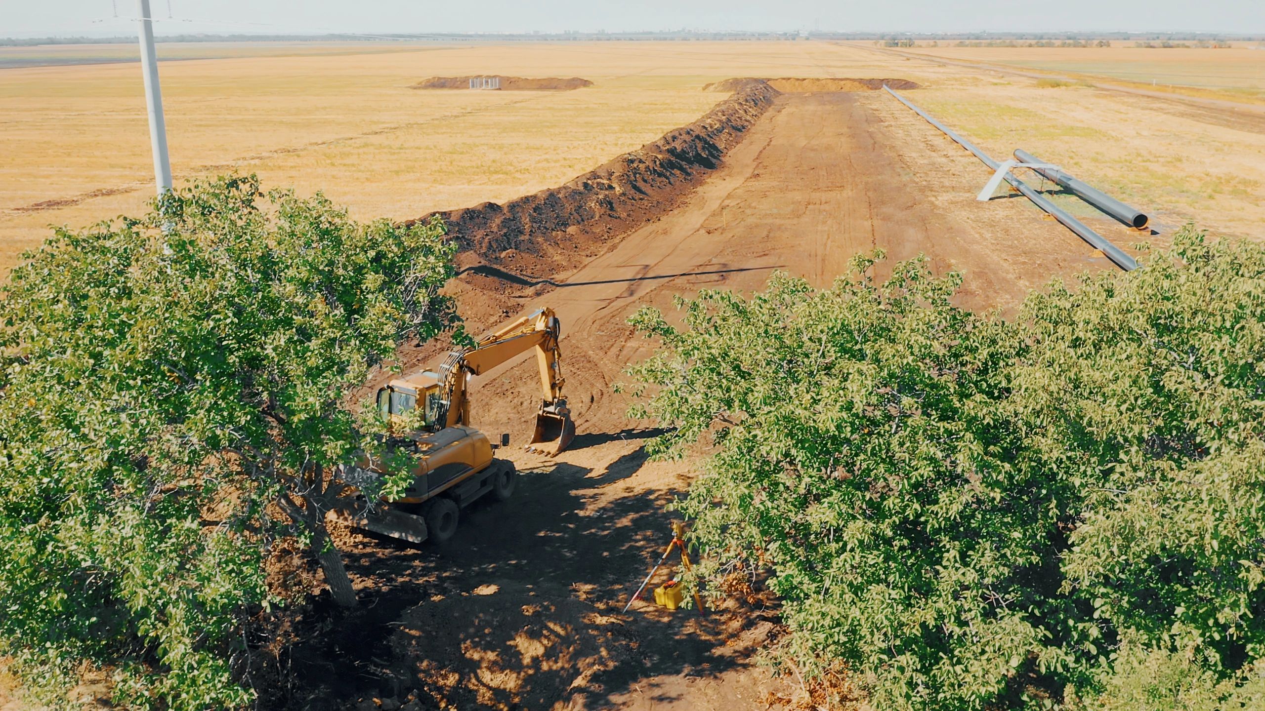 Excavator digging a trench at a construction site